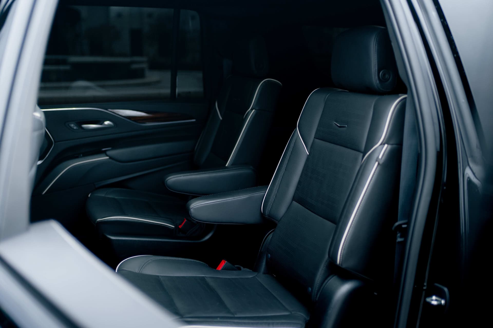 Black Cadillac Escalade ESV with vertical LED lights in a dark studio