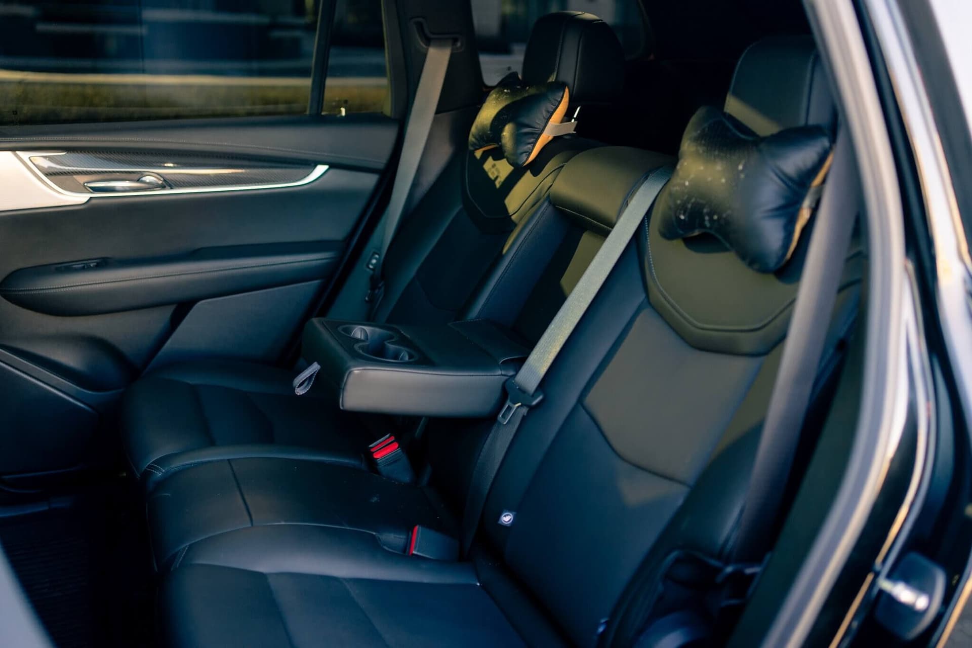 Black Cadillac XT6 luxury SUV in a dark studio with gold accents