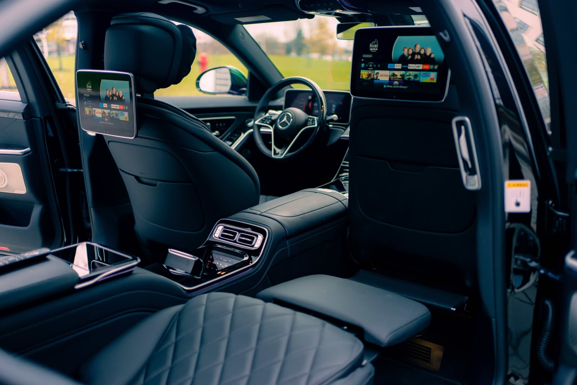 Black Mercedes-Benz S580 in dramatic golden studio light